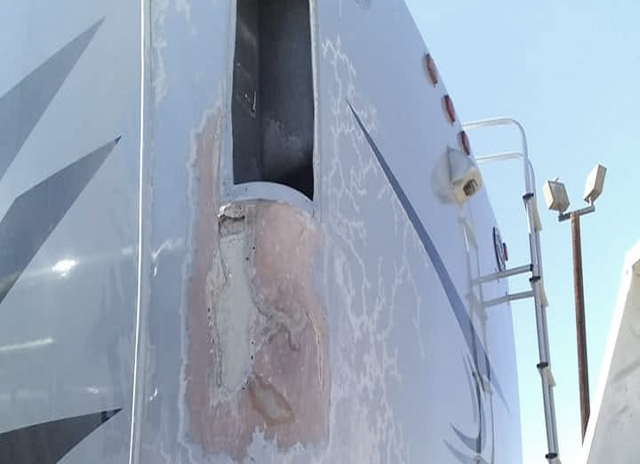 RV sidewall with fiberglass damage before repair