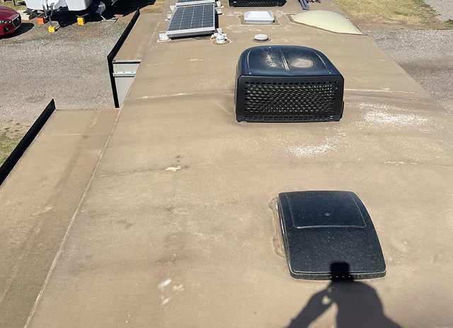 Weathered RV roof before resealing